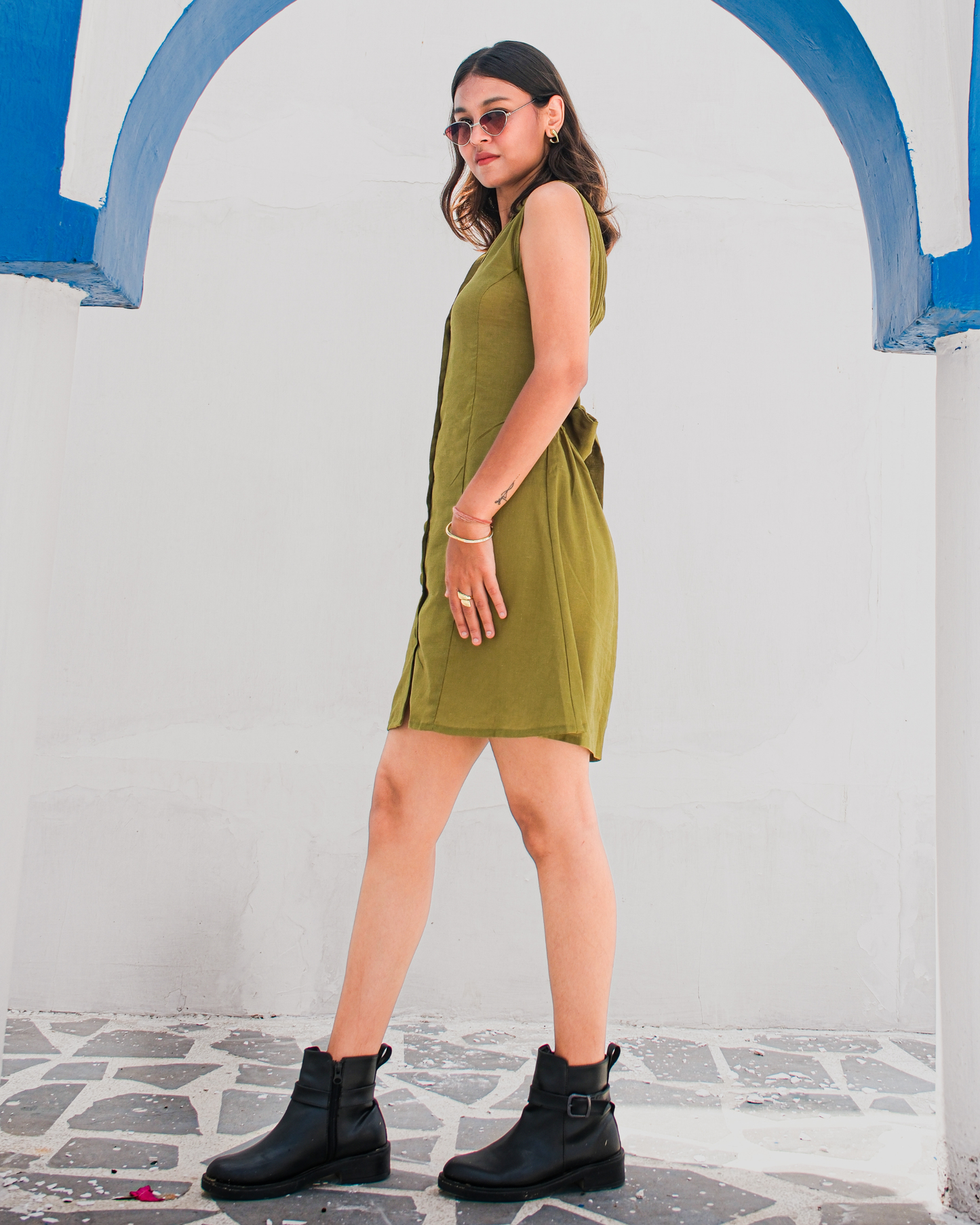 women in a olive green shirt dress that has front button placket and back tie design by moodora