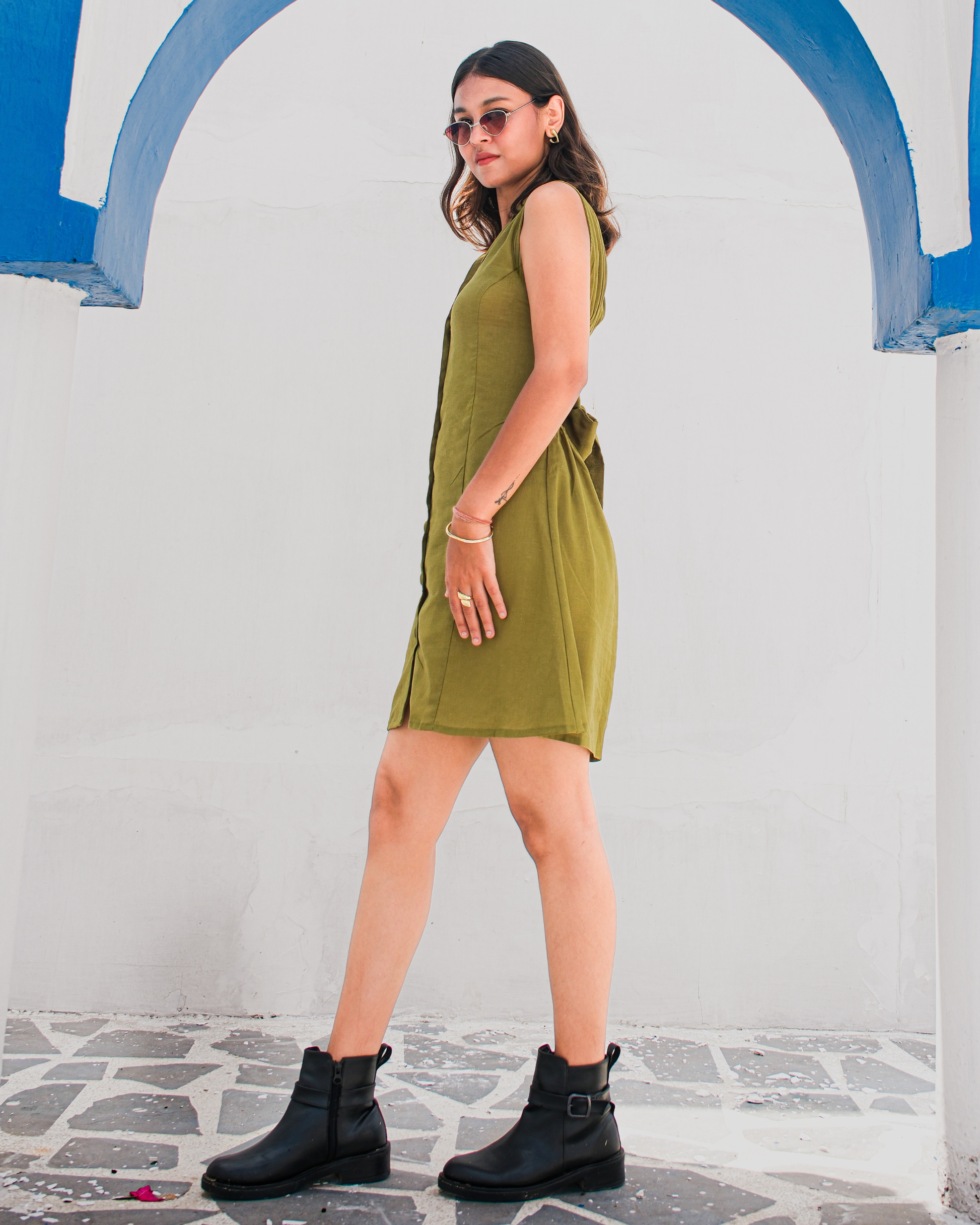women in a olive green shirt dress that has front button placket and back tie design by moodora