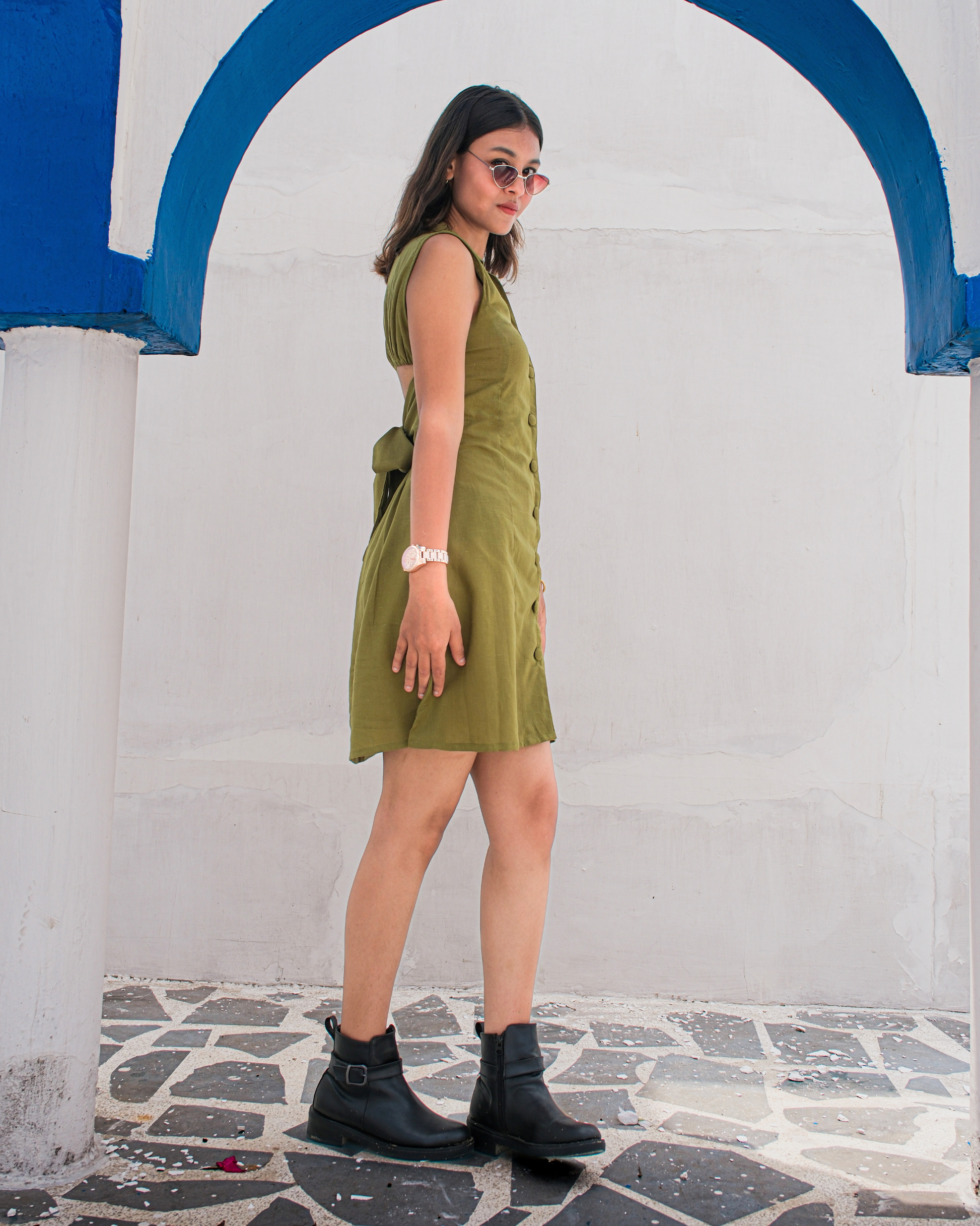 women in a cotton linen shirt dress with back tie details styled with boots and watch for a powerful look.