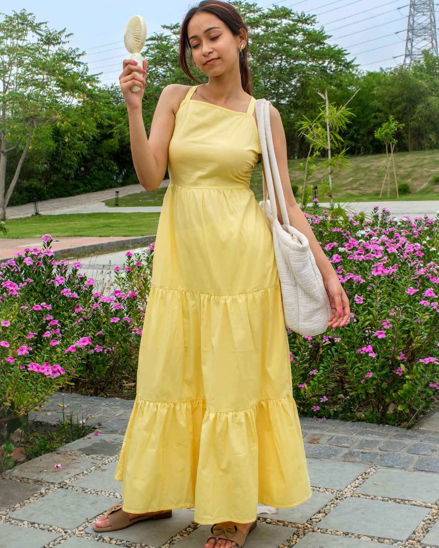 women in a pure cotton yellow tiered maxi dress which has back ties by a clothing brand called Moodora