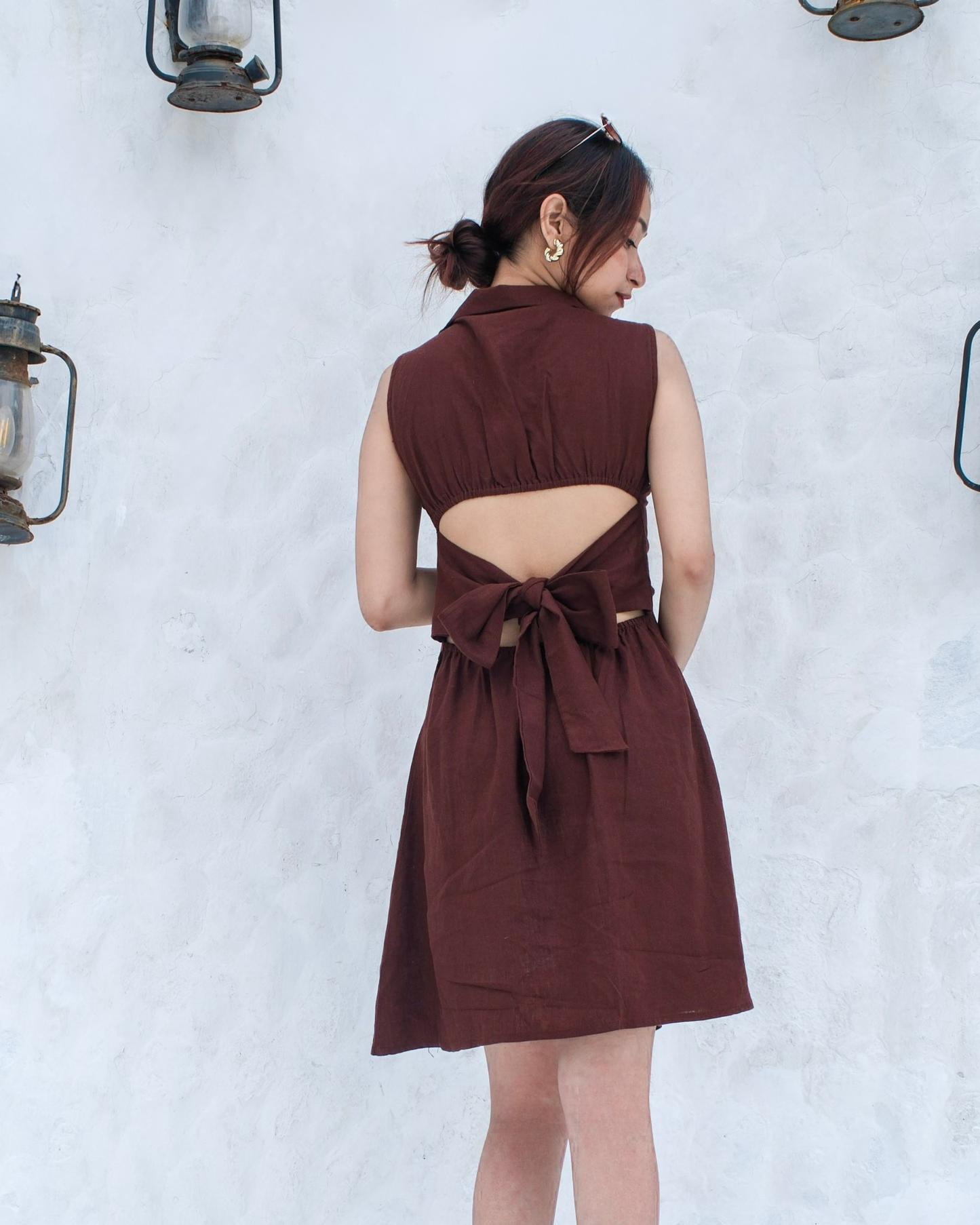 women wearing a linen shirt dress that has back cut out and tie up details with collared neck by moodora