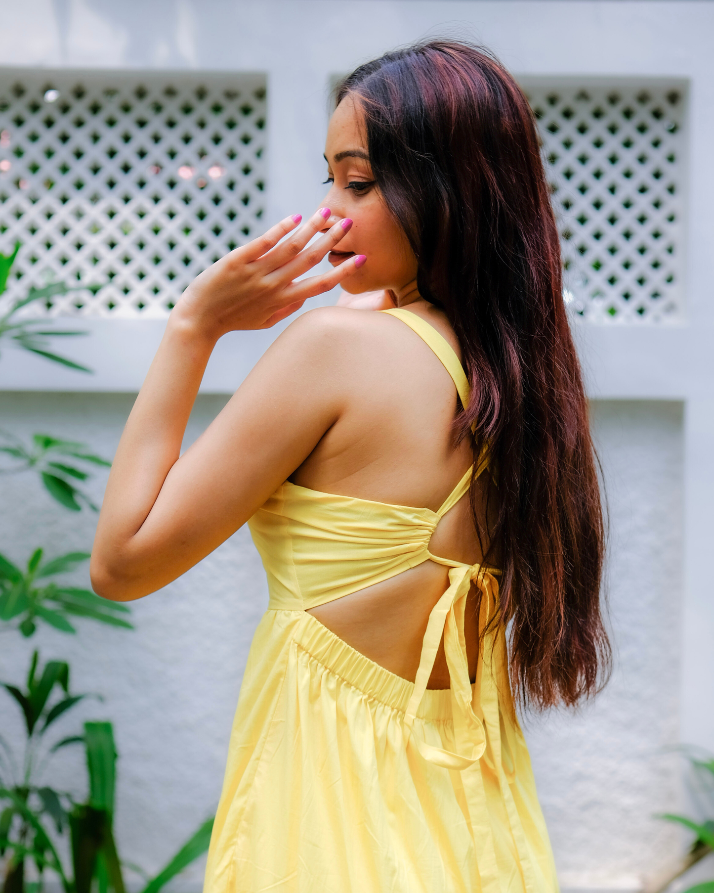 women in a pure cotton yellow tiered sleeveless maxi dress which has back ties by a clothing brand called Moodora perfect for birthday or summer vacations