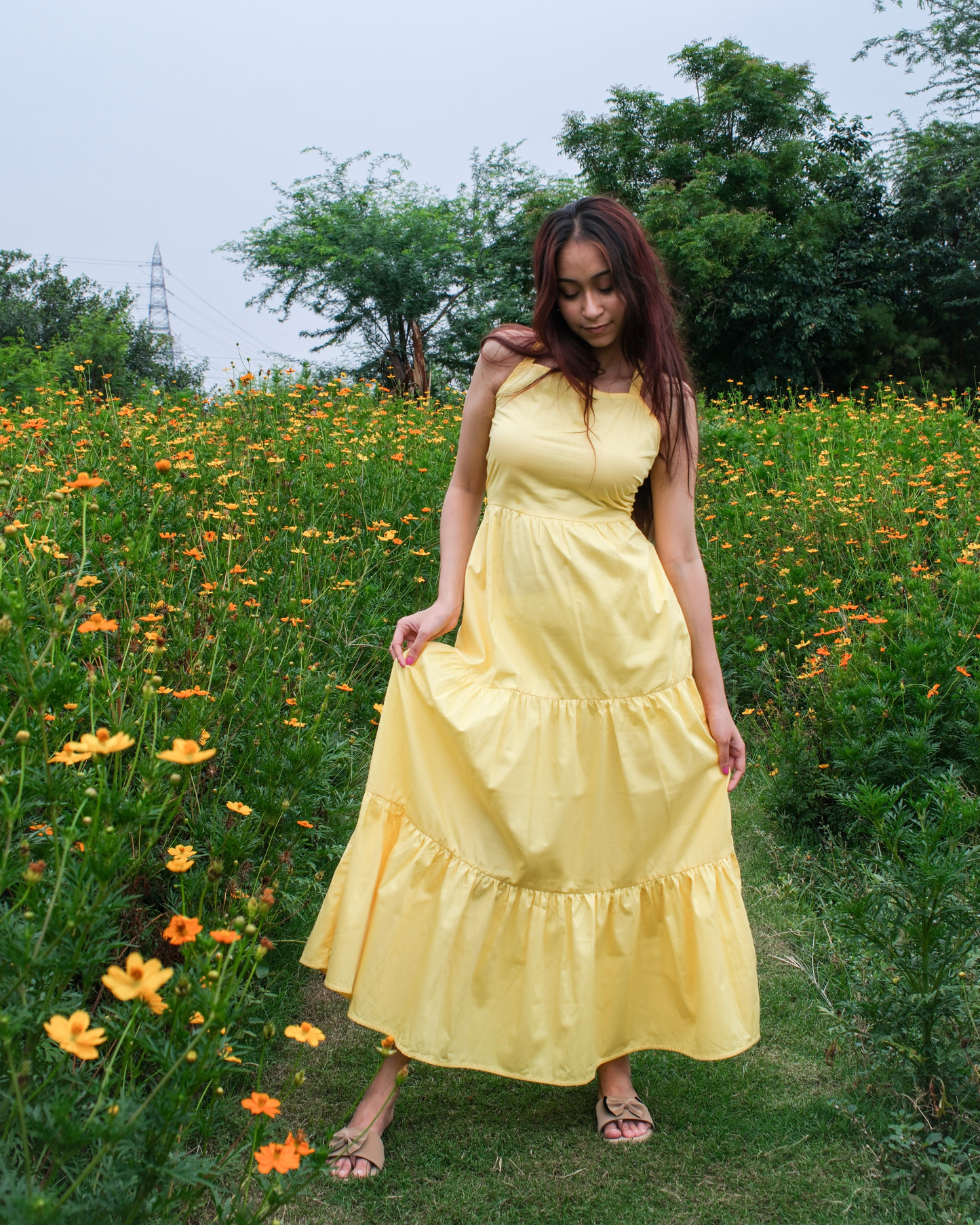 women in a moodora pure cotton yellow tiered sleeveless maxi dress for summer outings and vacation at beaches.