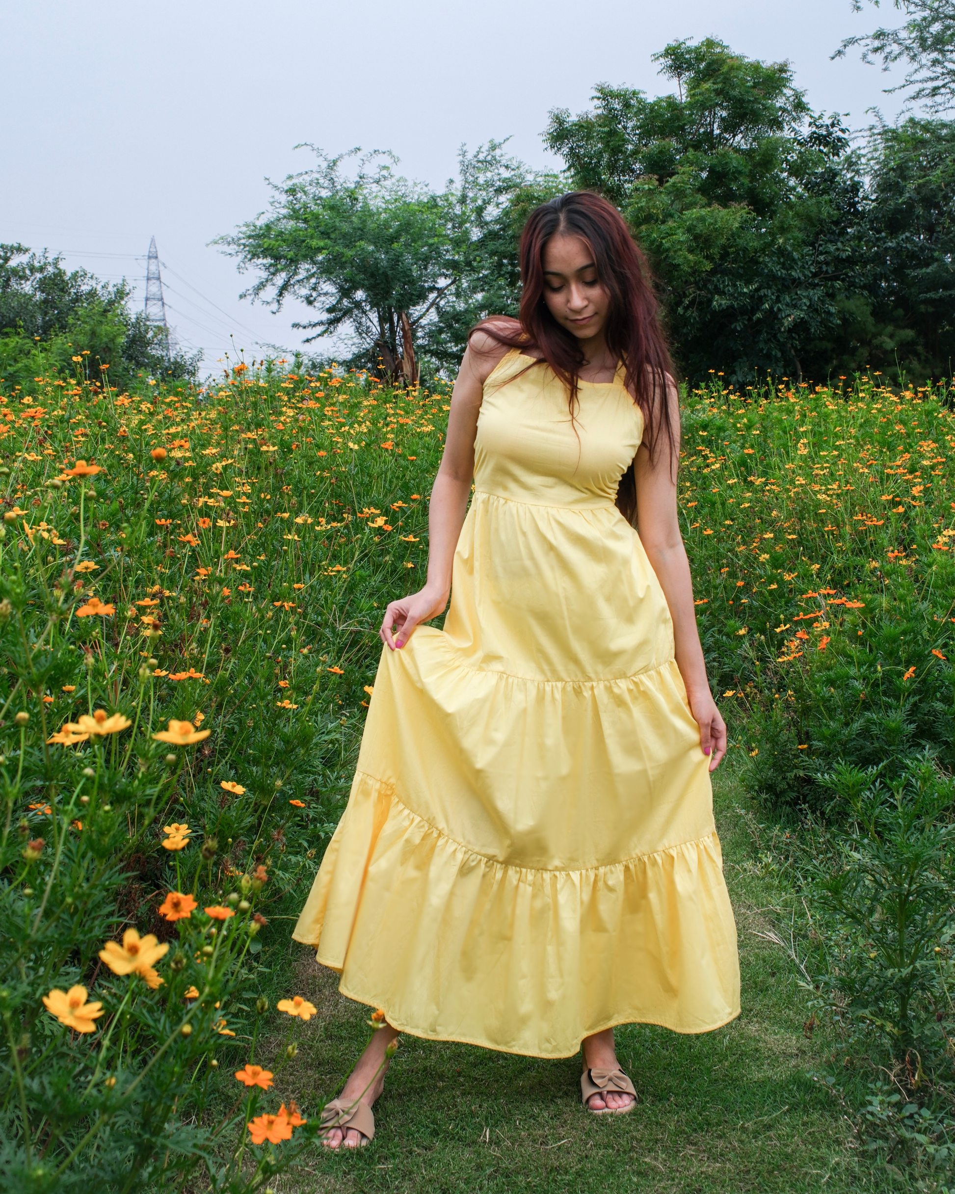 women in a moodora pure cotton yellow tiered sleeveless maxi dress for summer outings and vacation at beaches.