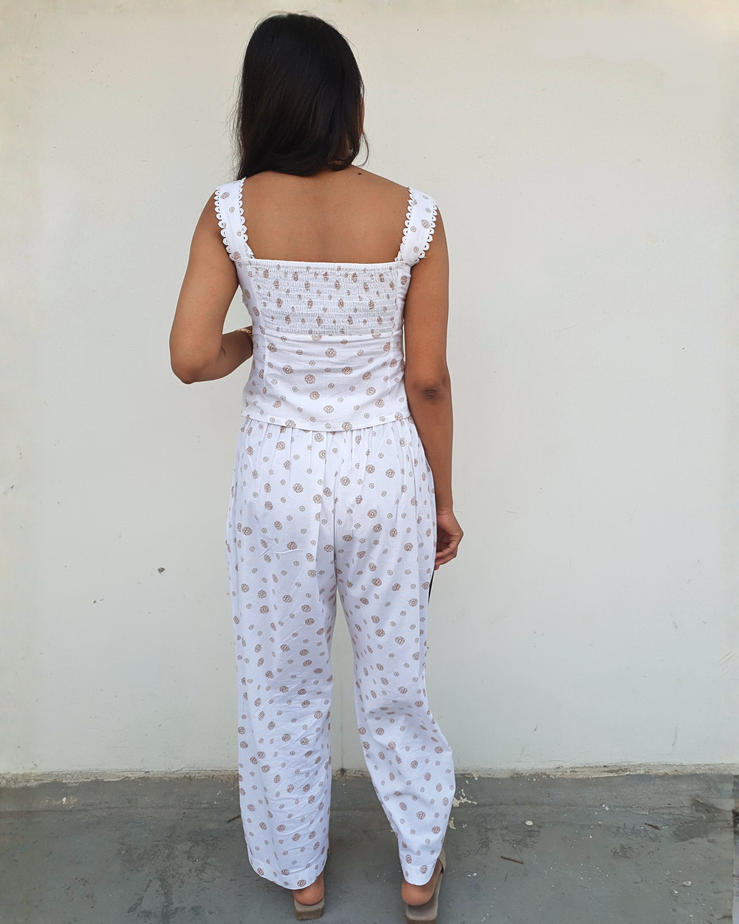 women wearing a white pure cotton everyday wear co ord set by moodora showing the back design where top comes with full elasticated back and zipper