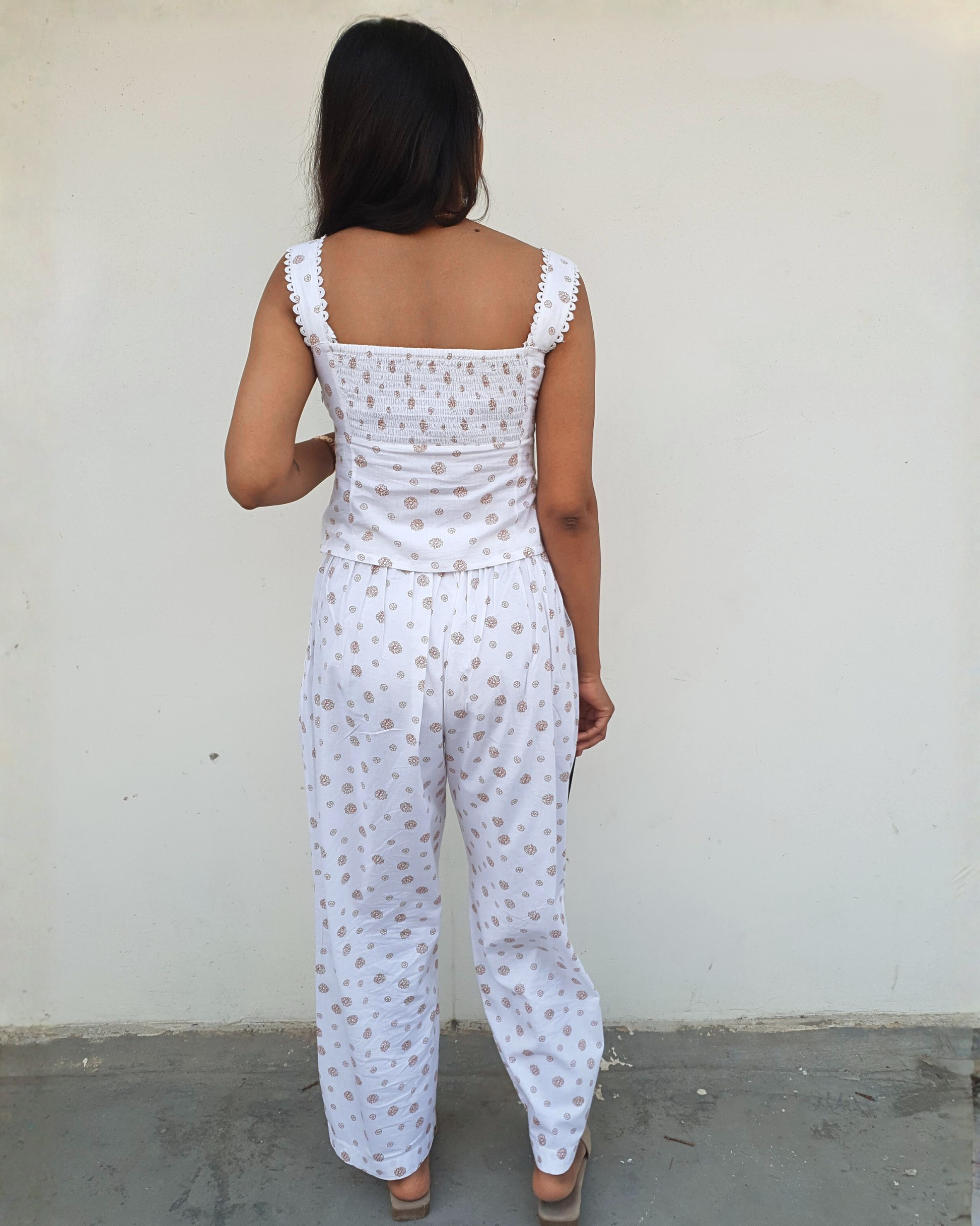 women wearing a white pure cotton everyday wear co ord set by moodora showing the back design where top comes with full elasticated back and zipper