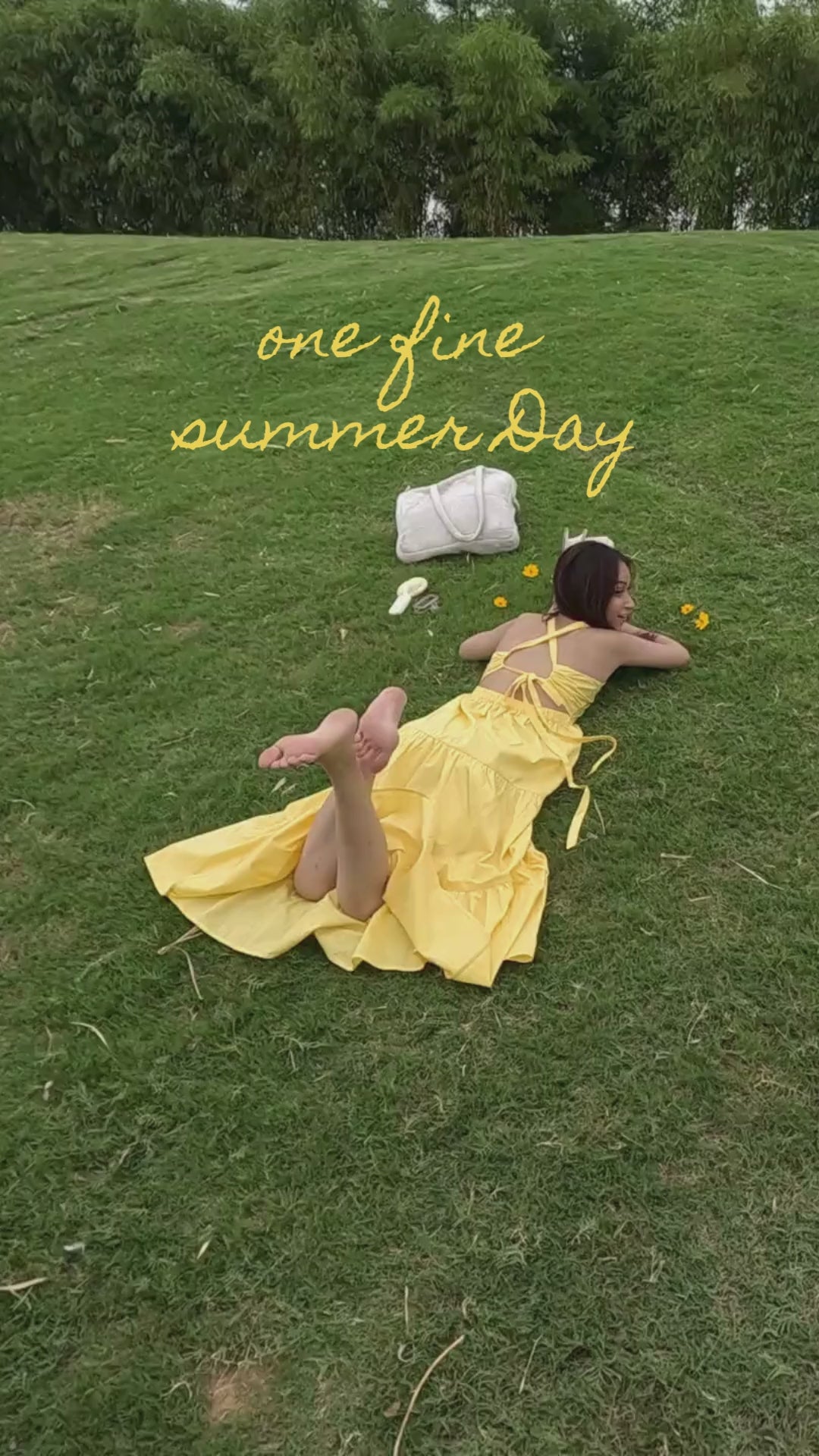 Load video: a woman lying on the ground wearing moodora dress and reading a book with at peace emotions.